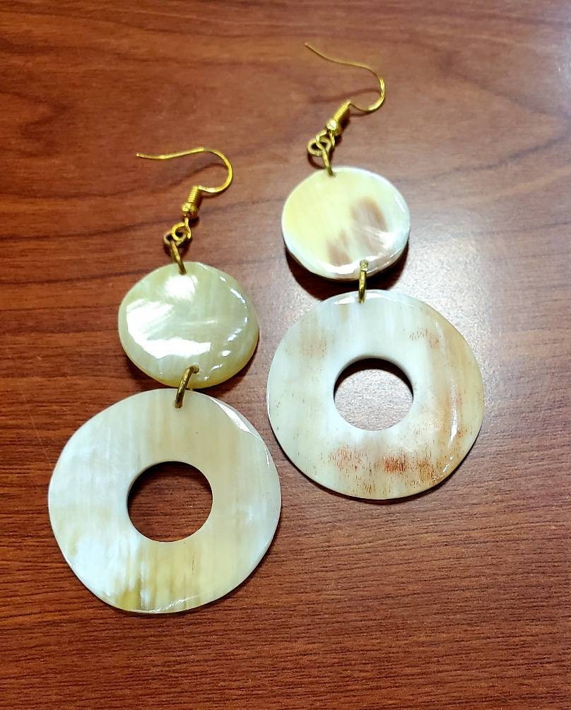 Round Dangling Cowhorn Earrings.