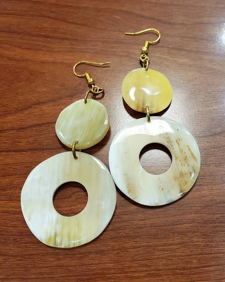 Round Dangling Cowhorn Earrings.