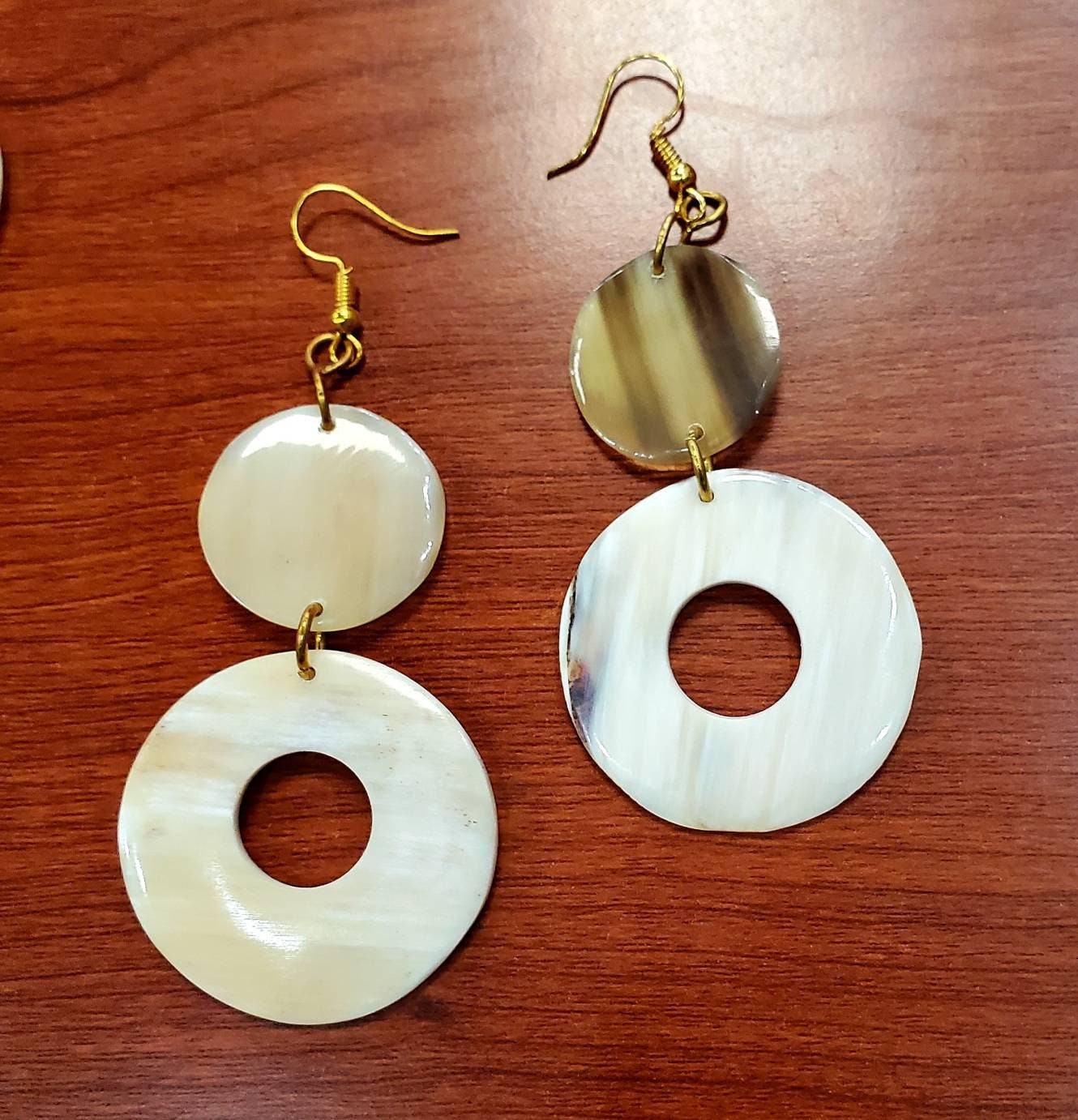 Round Dangling Cowhorn Earrings.