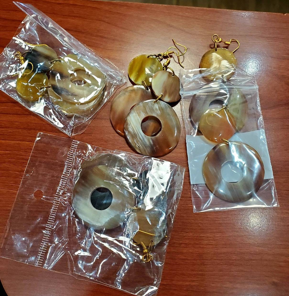 Round Dangling Cowhorn Earrings.