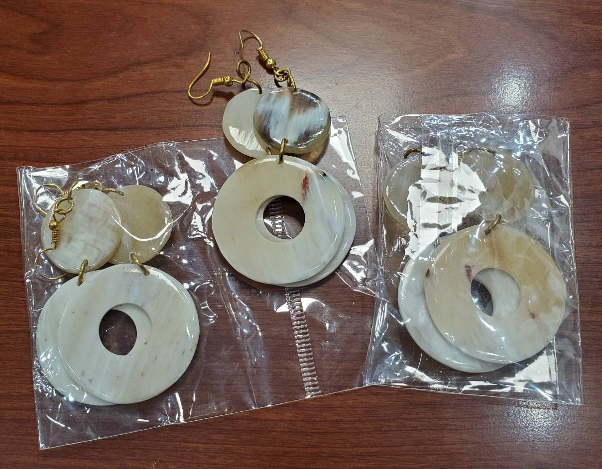 Round Dangling Cowhorn Earrings.