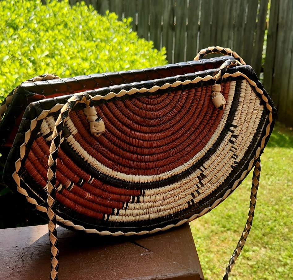 Small Round Bottom Burkina Rafia Purse/African Rafia Bag. Front Leather Art and Zipper Closure.