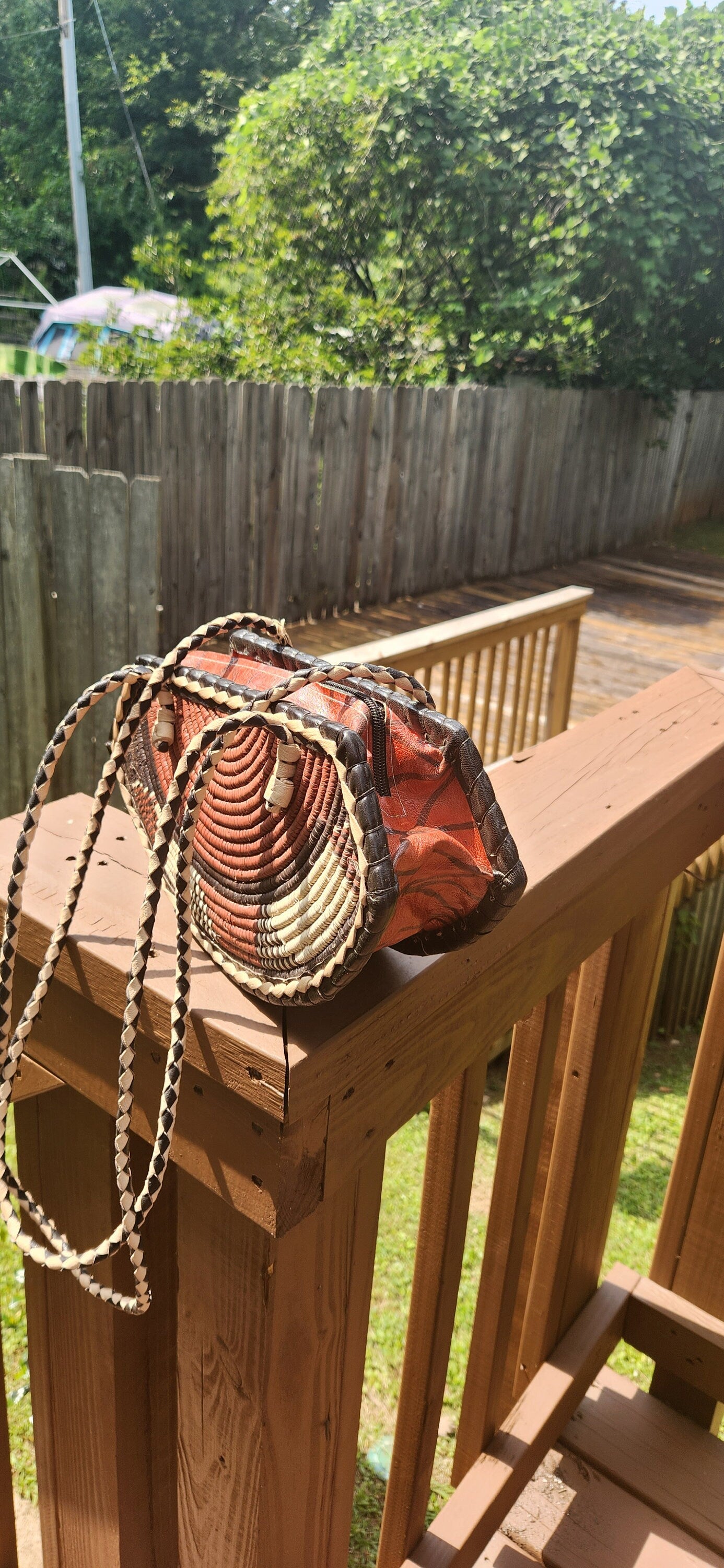 Small Round Bottom Burkina Rafia Purse/African Rafia Bag. Front Leather Art and Zipper Closure.